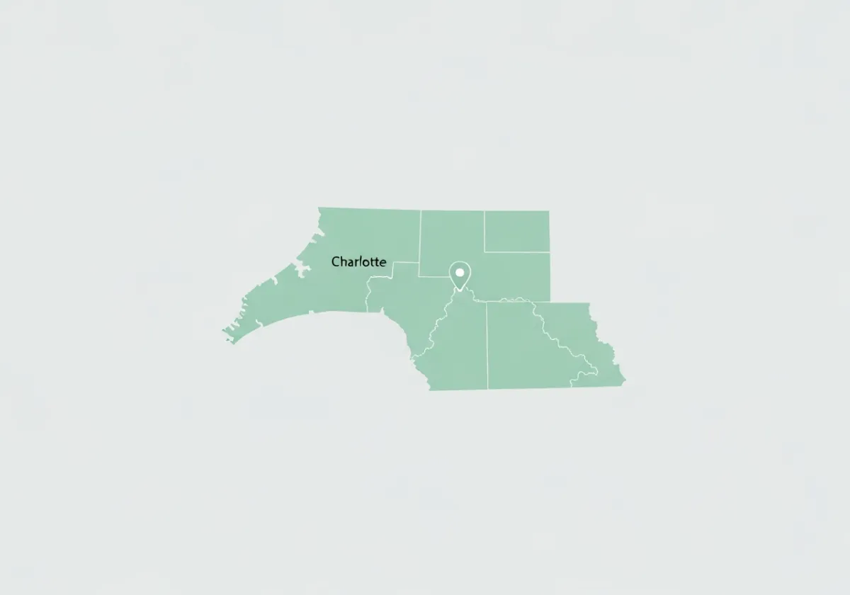 A minimalist light green map graphic showing the service area of North Carolina, South Carolina, southern Virginia, and northern Georgia, with Charlotte marked as a central hub