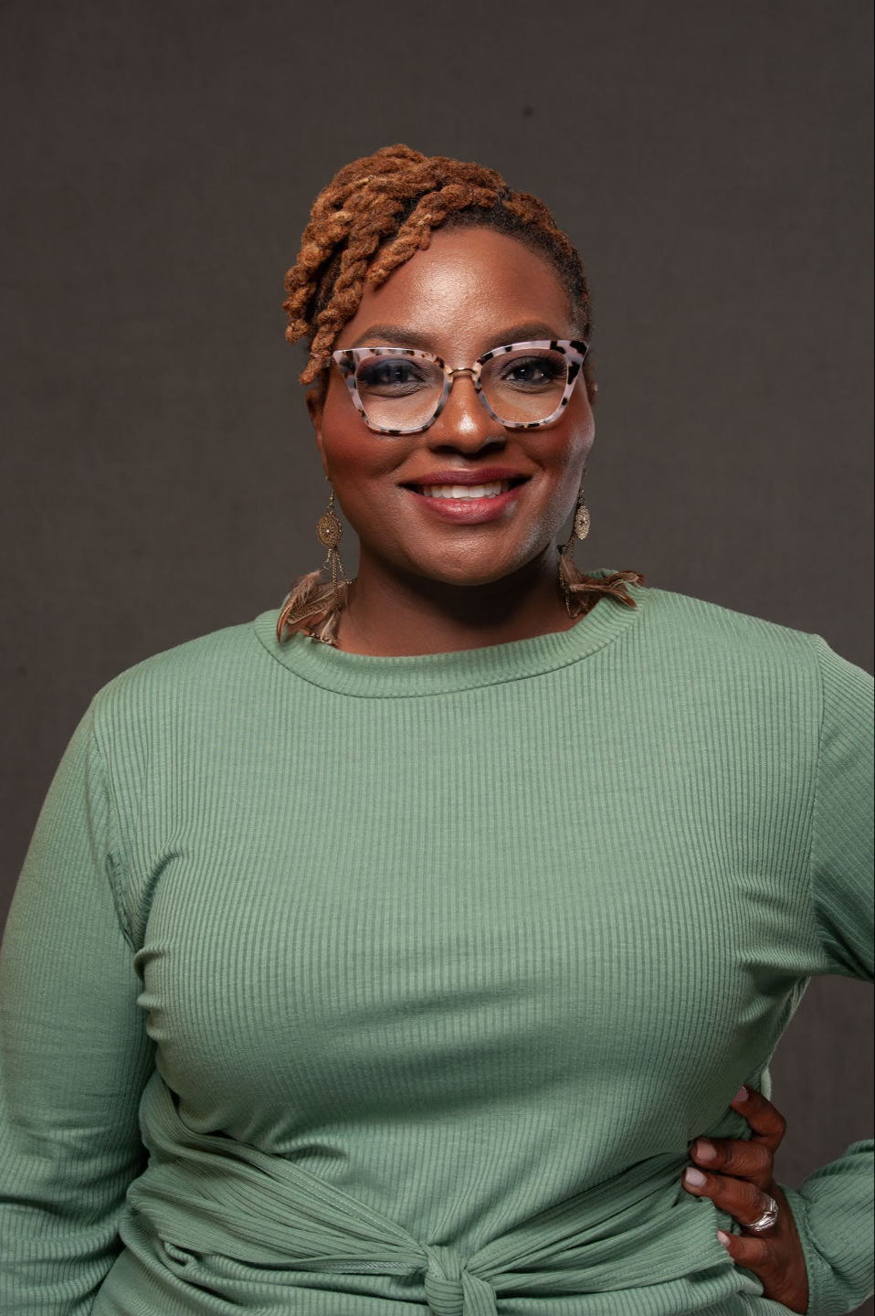 Woman in green top with crossed arms