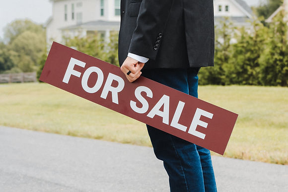 Eddie Brady with Showcase Real Estate, LLC holding a for sale sign