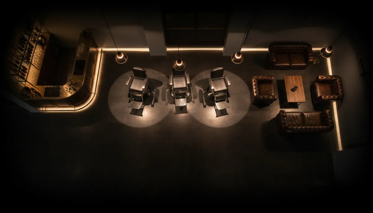 Overhead view of luxury barbershop lounge with dim lighting