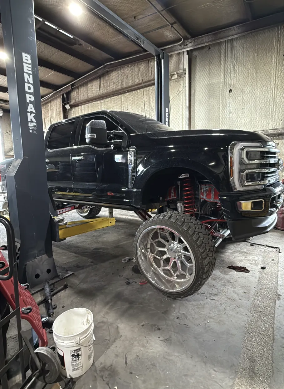 Lifted truck on shop lift
