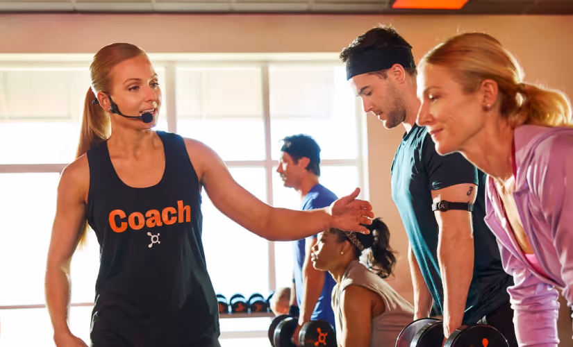 Certified Coach adjusting treadmill