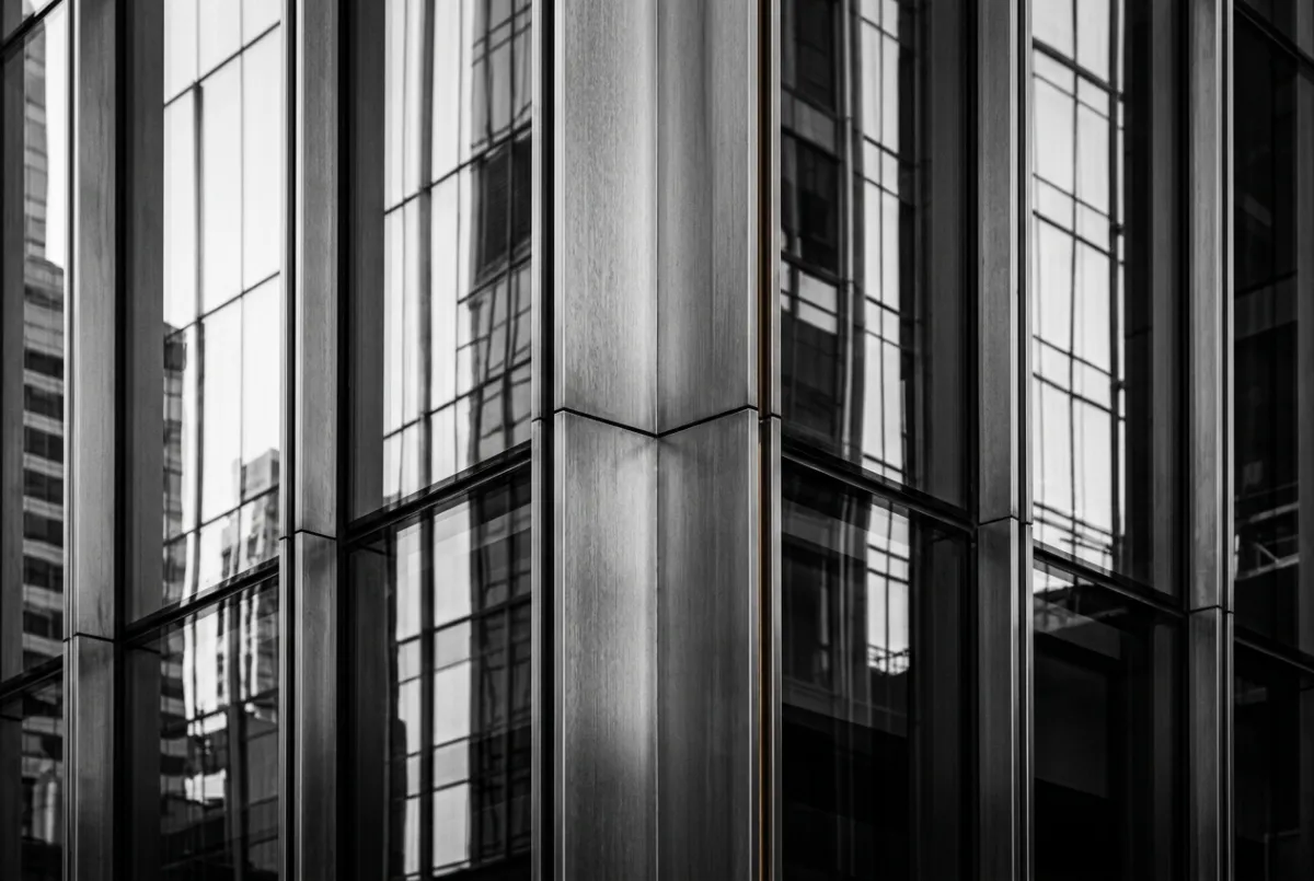 Clean architectural steel truss and glass facade detail in a corporate commercial structure