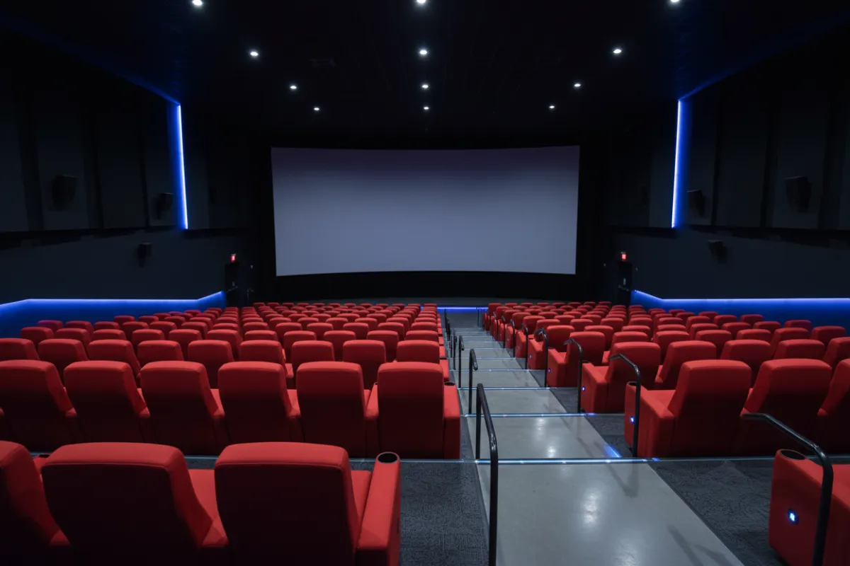 Interior of Regal Springfield - plush red seats, large screen, blue lighting