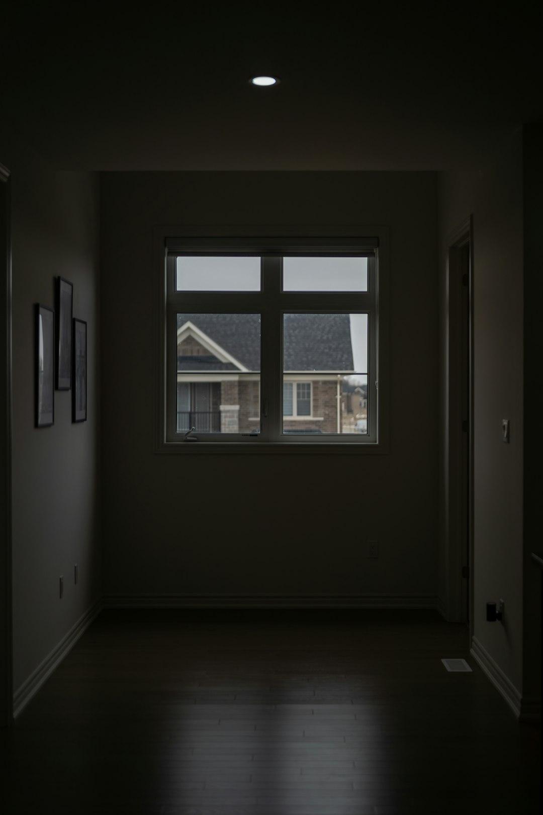 Dark moody view into a room with a window