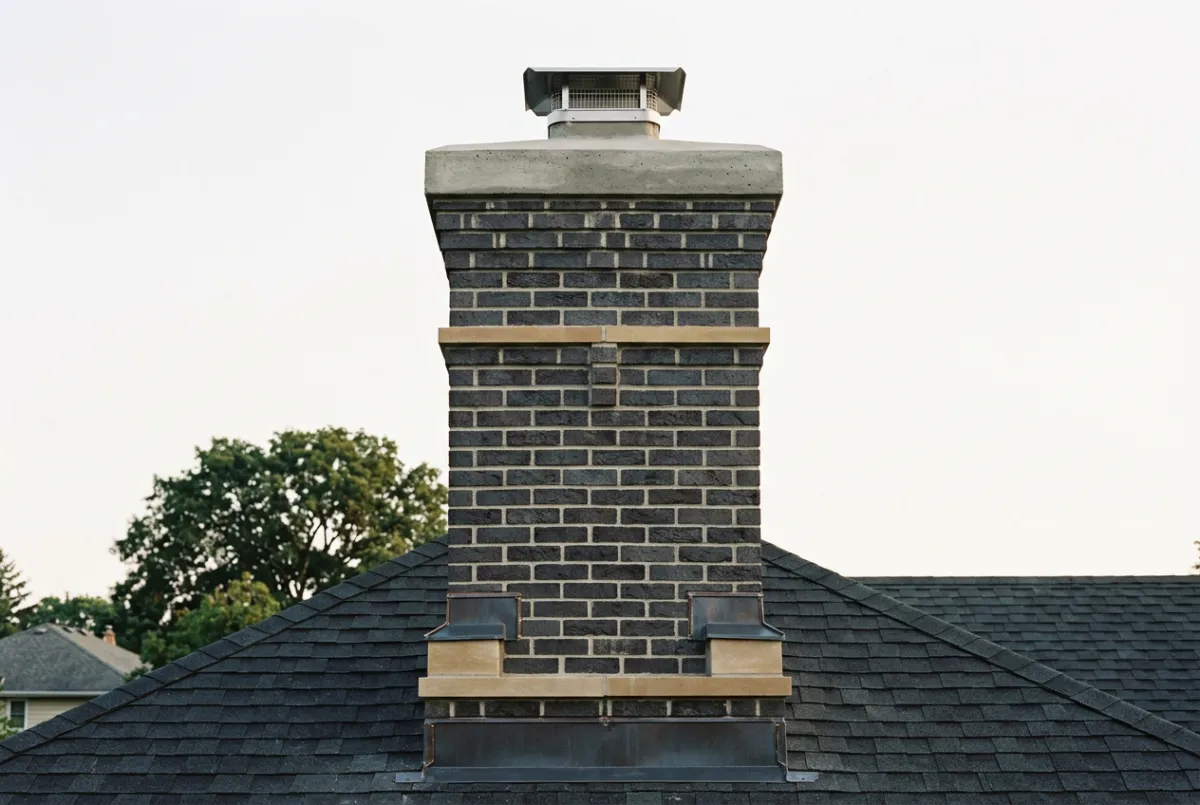Rebuilt brick chimney with poured concrete crown and flashing