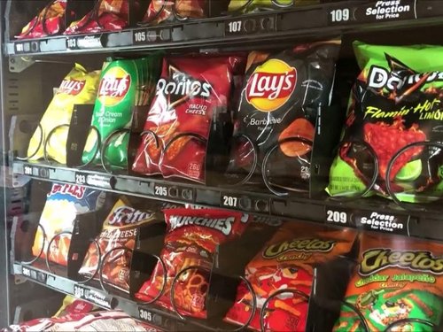 A photo of snacks in a vending machine.
