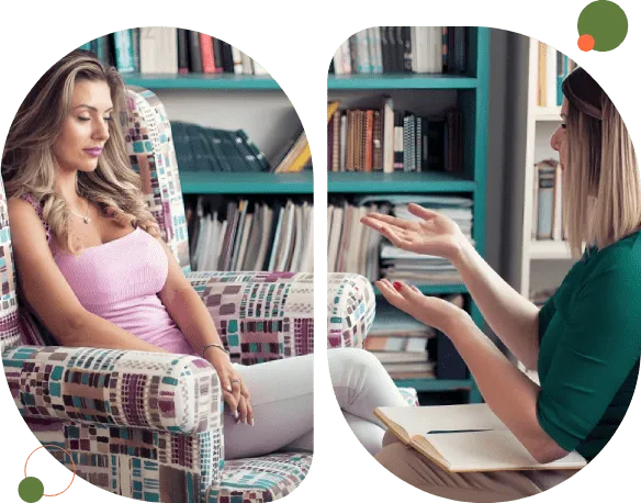 Two women engaged in a thoughtful conversation in a cozy library setting.