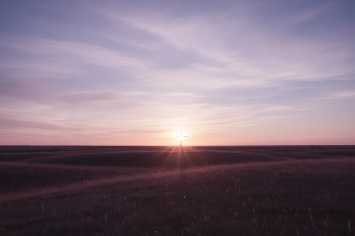 Album cover showing dawn landscape with a single cross silhouette under a lavender sky.