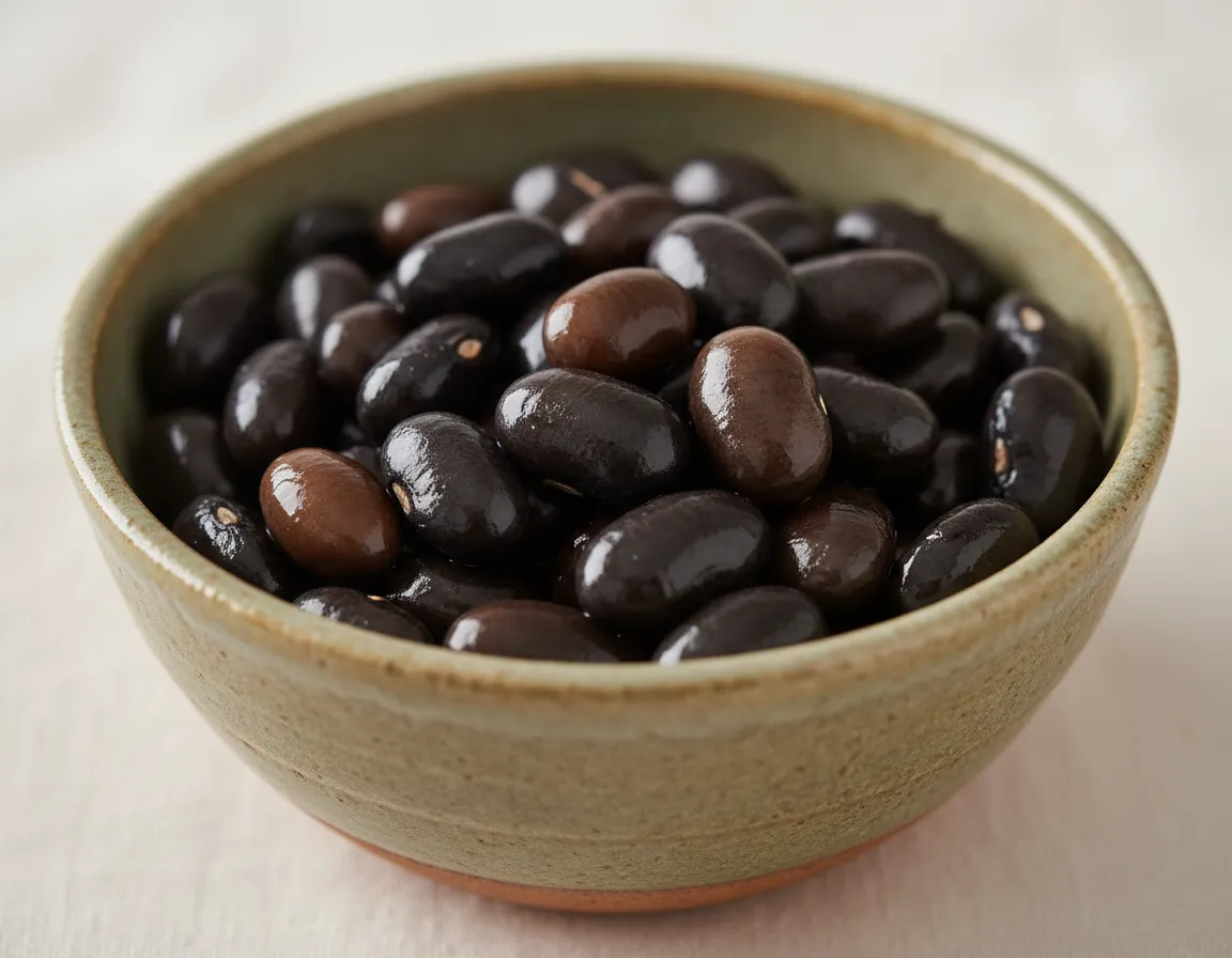 Earthy black beans gathered in a ceramic bowl