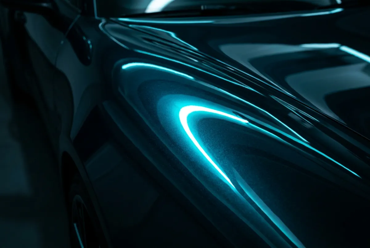 Macro high-gloss automotive paint reflection showing specular highlights