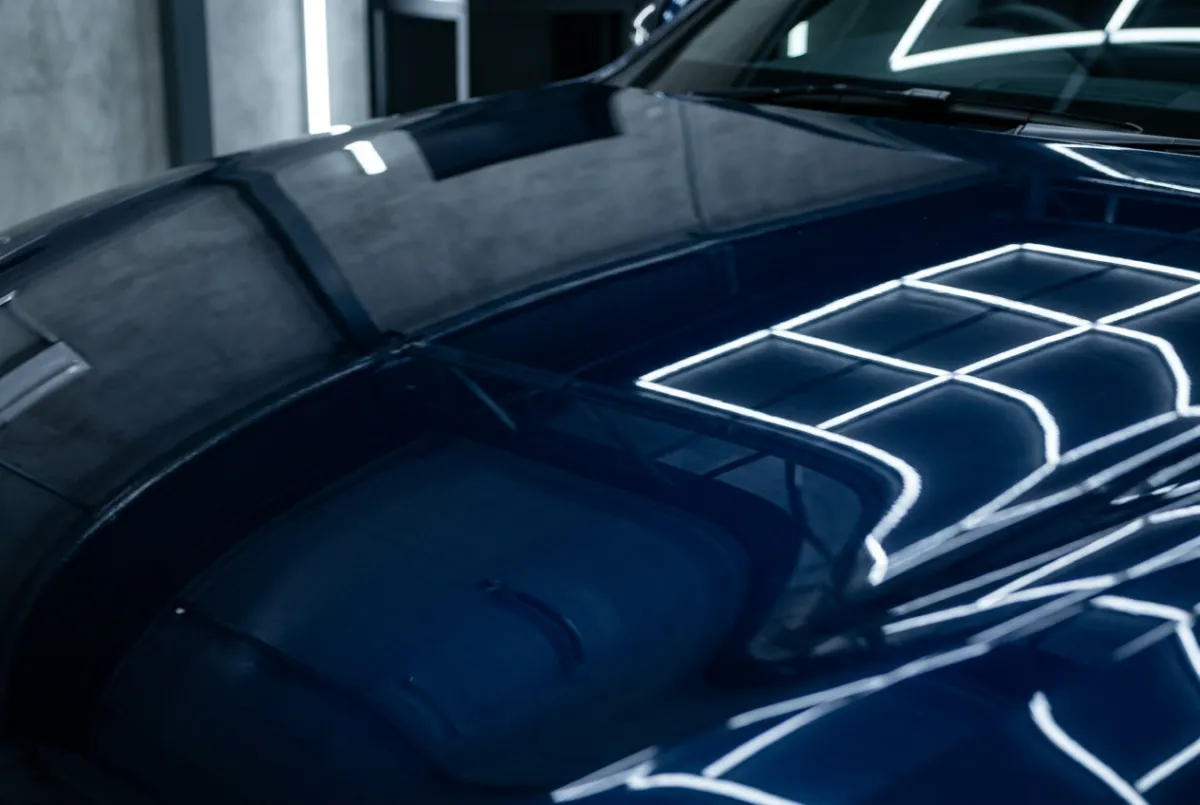 Macro high-contrast reflection on mirror-finish dark automotive clear coat