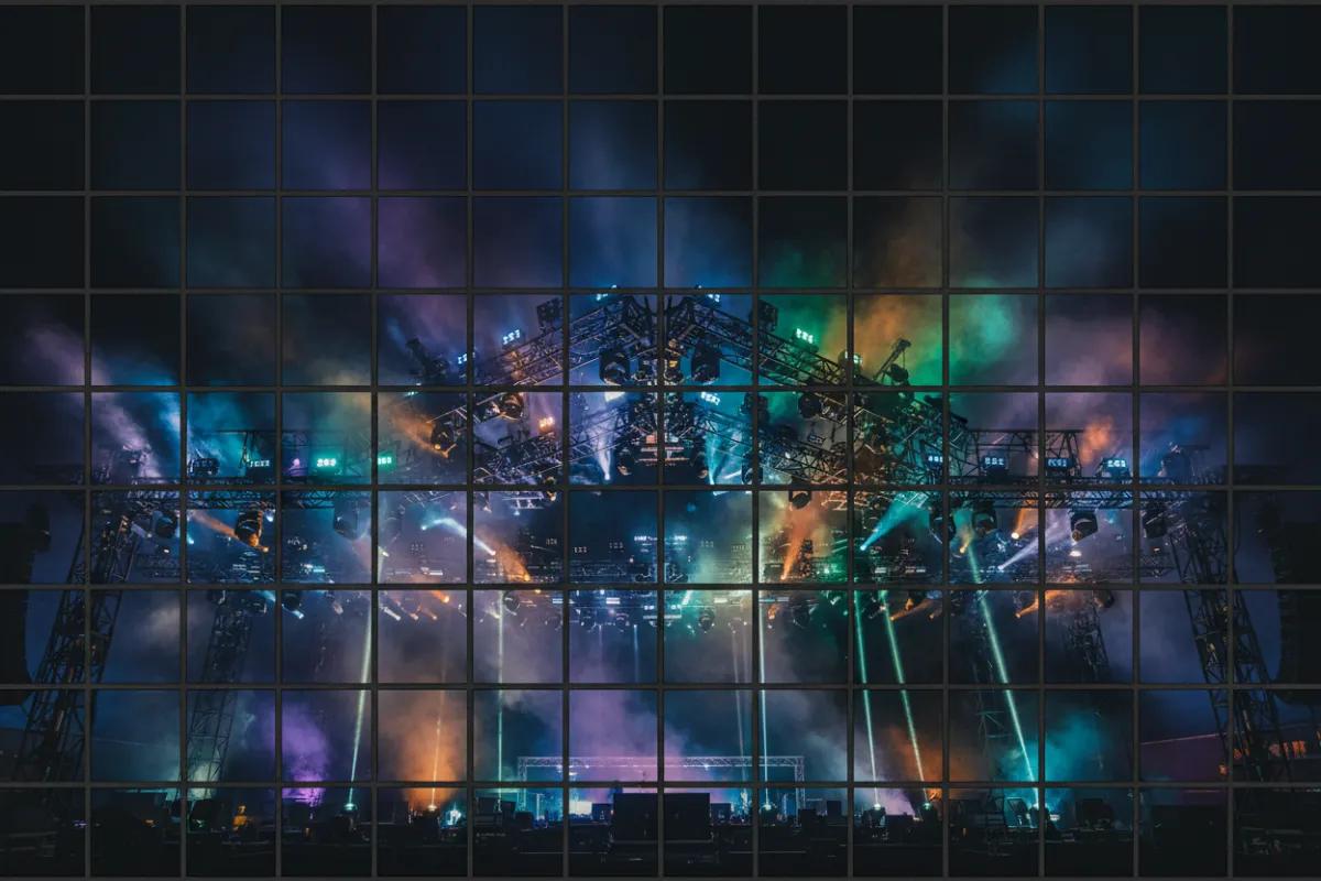 Landscape shot of festival lighting rig and smoke effects at an MMG show.