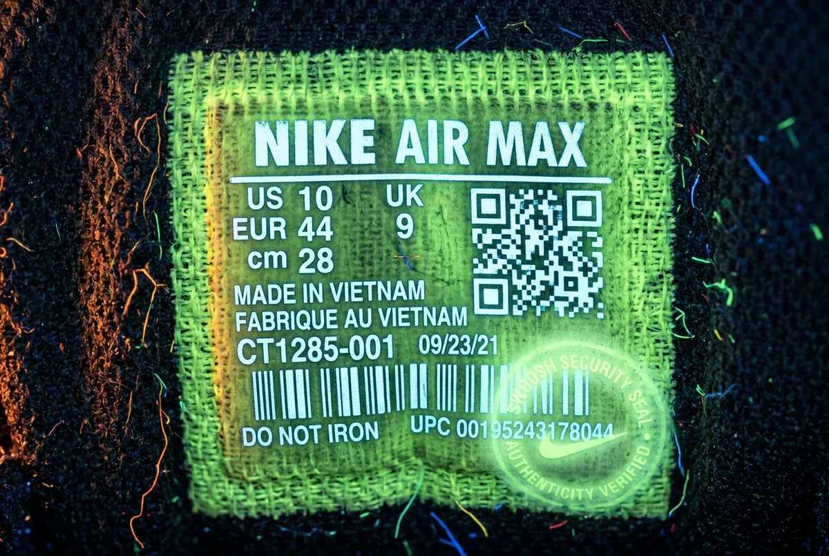 Macro view of sneaker size tag typography and UV security stamp