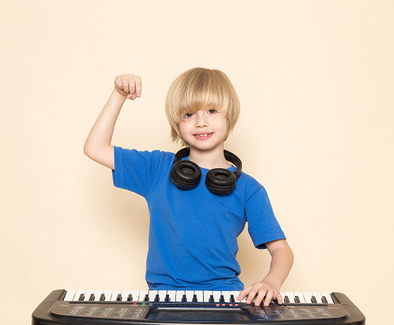 Boy learning piano at home