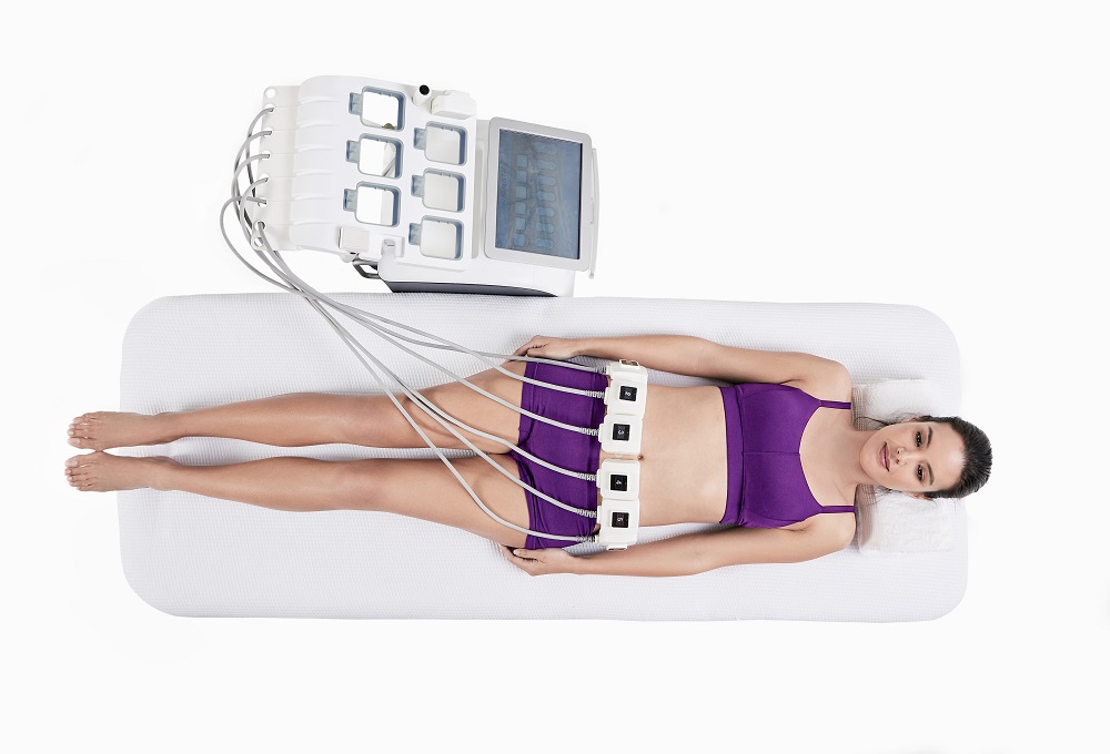 truSculpt iD body sculpting treatment device and patient receiving non-surgical fat reduction.