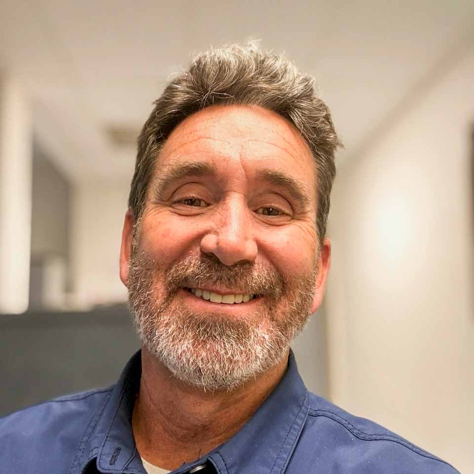 Calm coastal workspace with coffee on a desk near a window in morning light