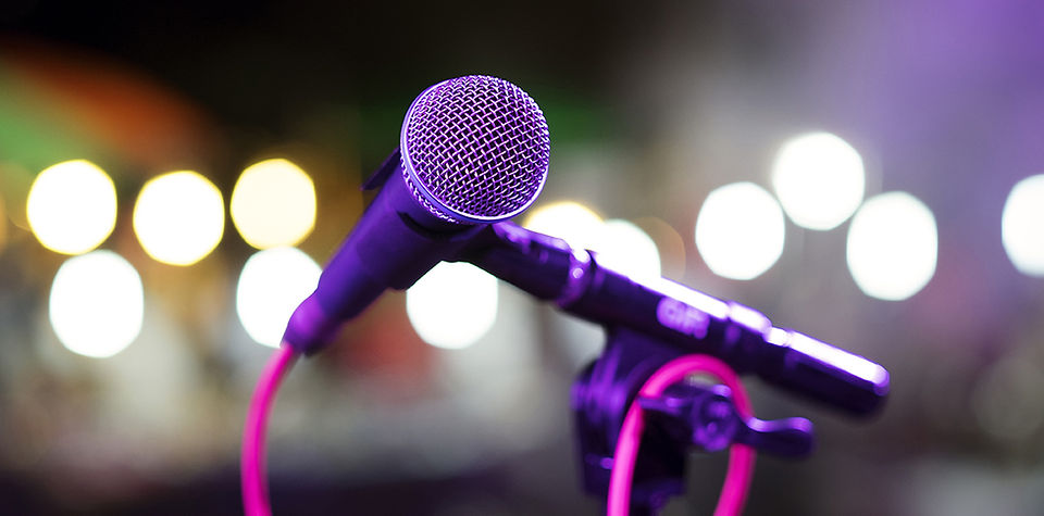 Microphone on a stand with blurred background lights