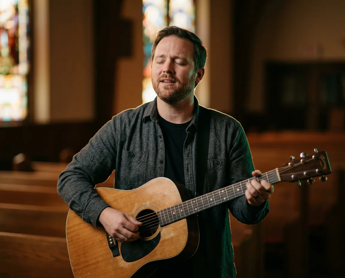 Director of Worship leading choir with acoustic guitar in warm sanctuary light