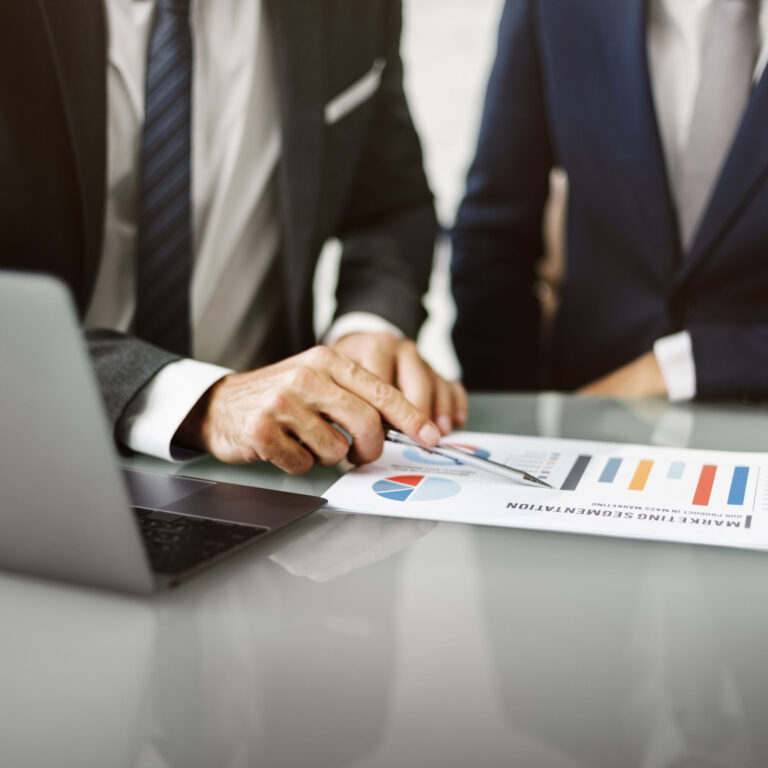 Professionals analyzing charts during a tax investigation