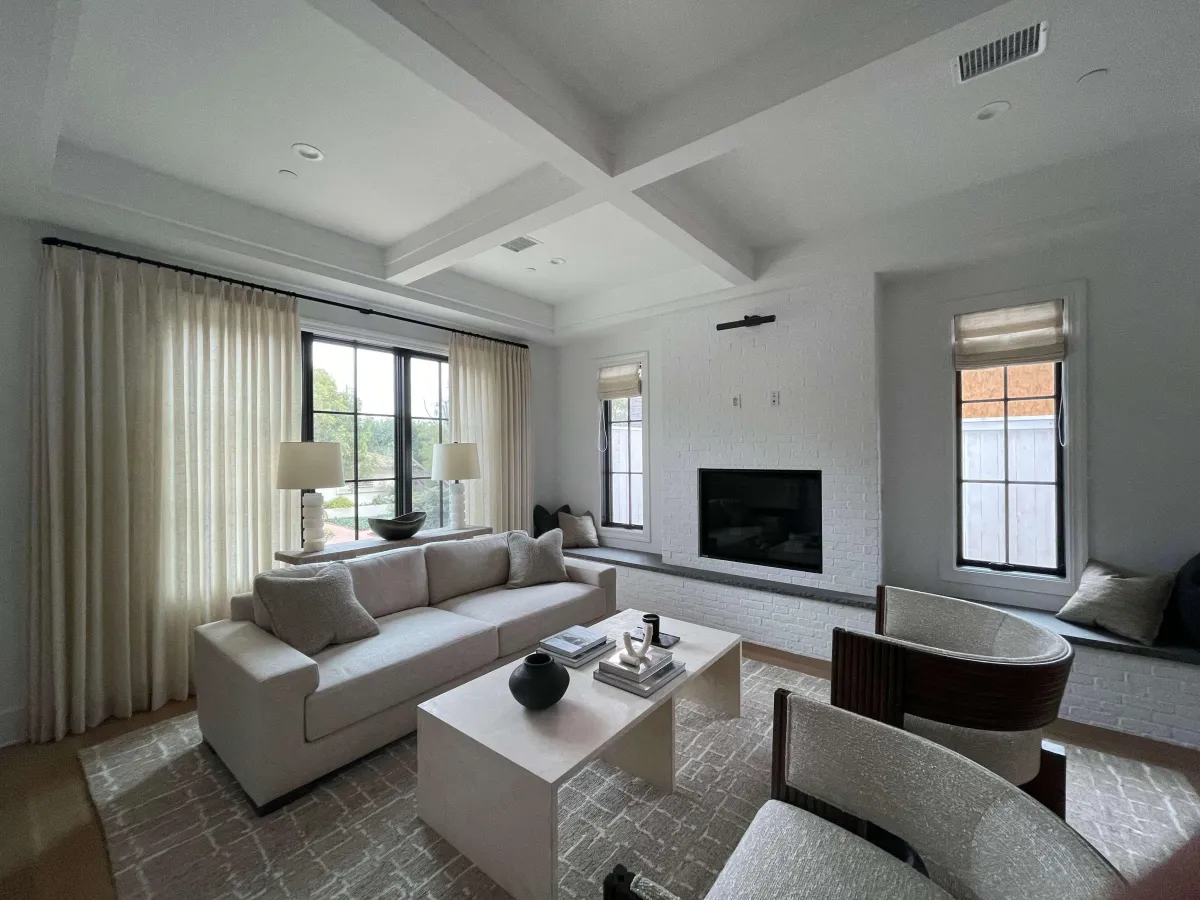 A beautifully designed living room featuring a mix of styles, colors, and textures, showcasing a personalized and cohesive design that reflects the homeowner's unique taste and personality.