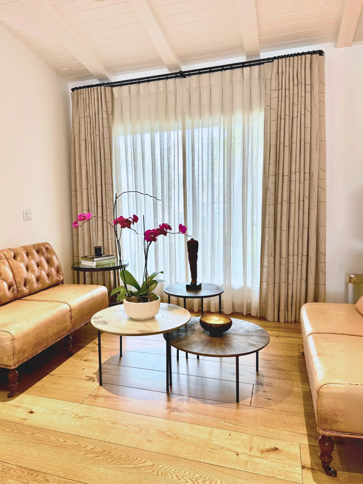 Elegant room with custom drapery that enhances height, light, and space, creating a cozy yet open atmosphere.
