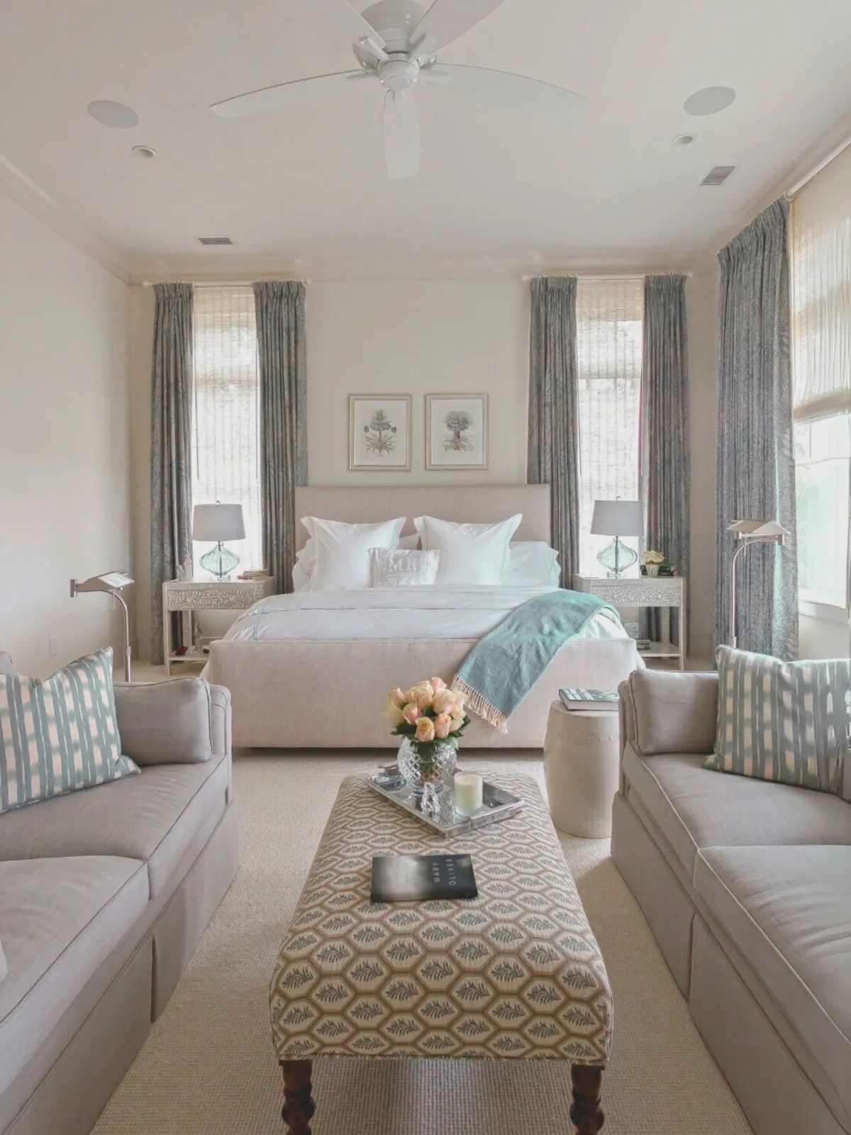 Elegant living room featuring modern drapery hardware with soft neutral curtains and coastal-inspired decor