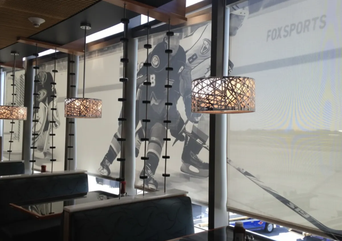 Beautiful living room with custom drapery and woven shades showing how window treatments transform a space without adding more décor