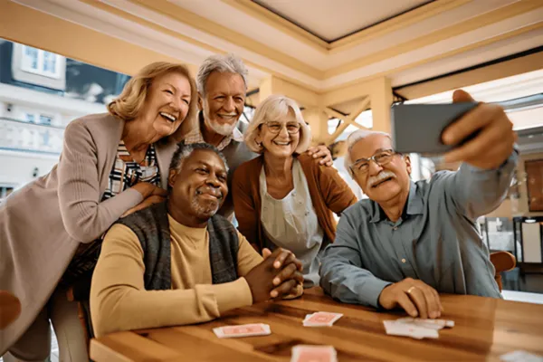 Senior citizens smiling and laughing while taking a selfie