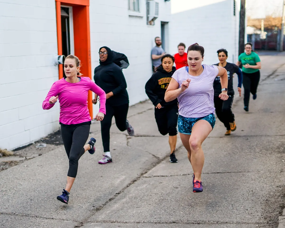 Solcana athletes running in a fitness class in Minneapolis, MN.
