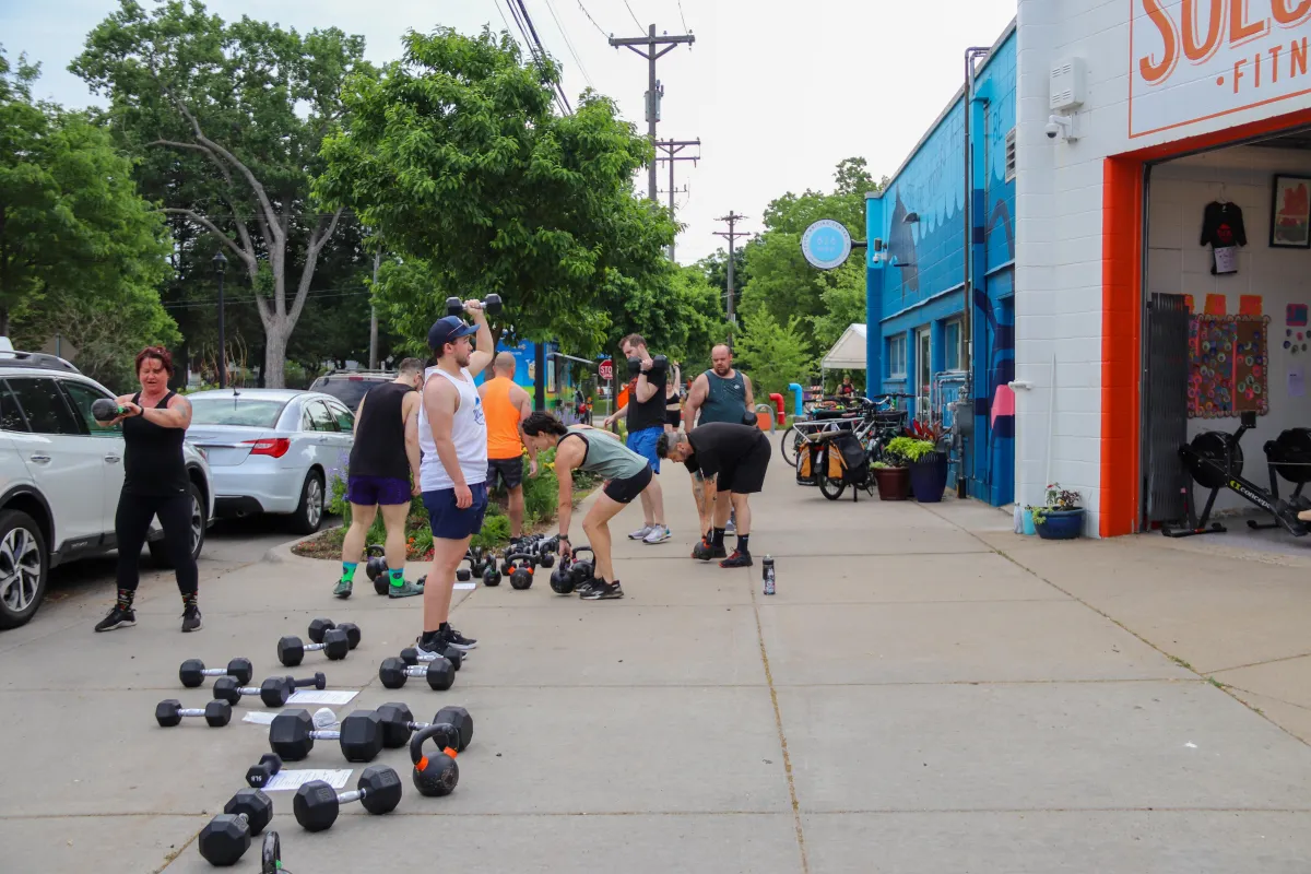People lifting weights outside
