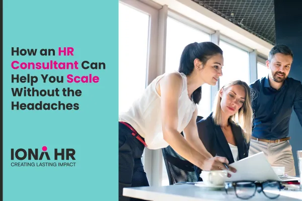 Three professionals collaborating in a modern office, reviewing documents together. Text on the image reads "How an HR Consultant Can Help You Scale Without the Headaches," alongside the IONA HR logo and tagline "Creating Lasting Impact."