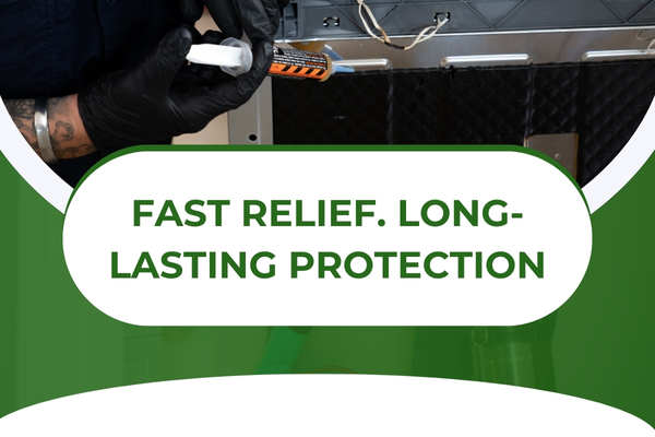 Technician applying roach control treatment under sink cabinet.