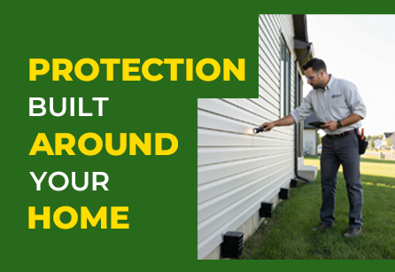 Pest control technician inspecting home exterior for pest entry points.