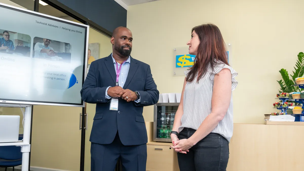 Business consultant Jemel Smith discussing strategy and growth opportunities with a business owner at a TaxAssist Advisors office