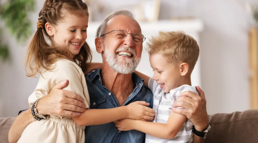 Older man with his two grandchildren.
