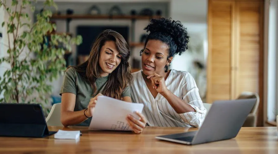 Two women researching loan options for ADUs