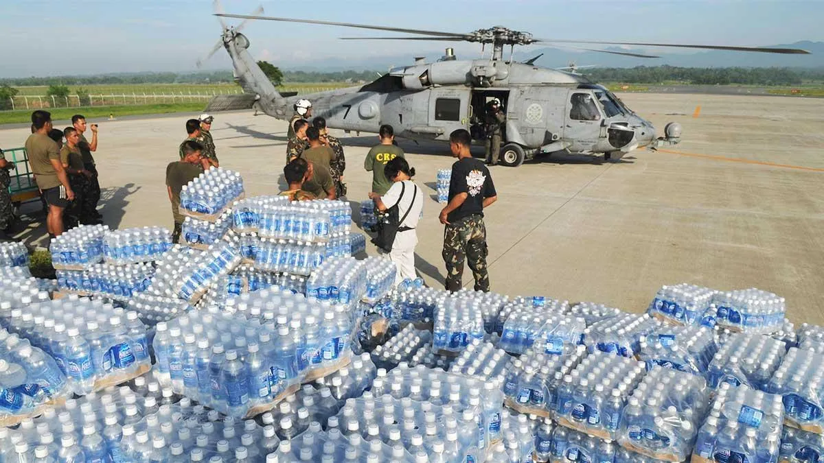 Image of armed forces delivering water bottles