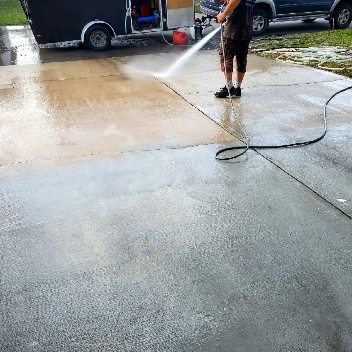 Man pressure washing driveway