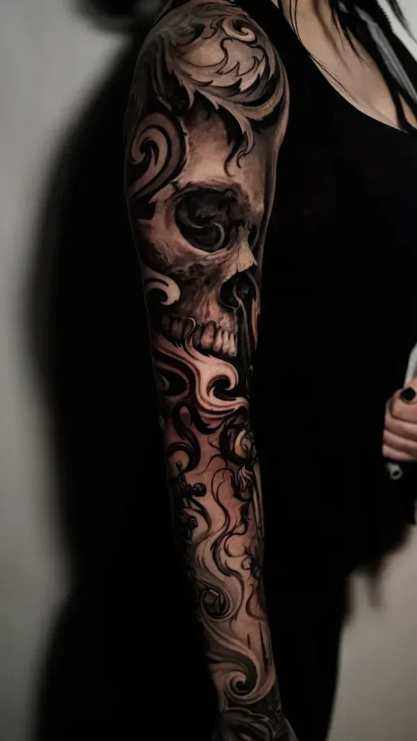 skull in motion black and grey surrealism tattoo: Professional tattoo by James Strickland at Montana Tattoo Company in Missoula, MT 