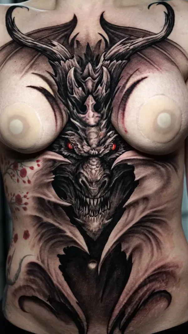 Sternum Dragon black and grey surrealism tattoo