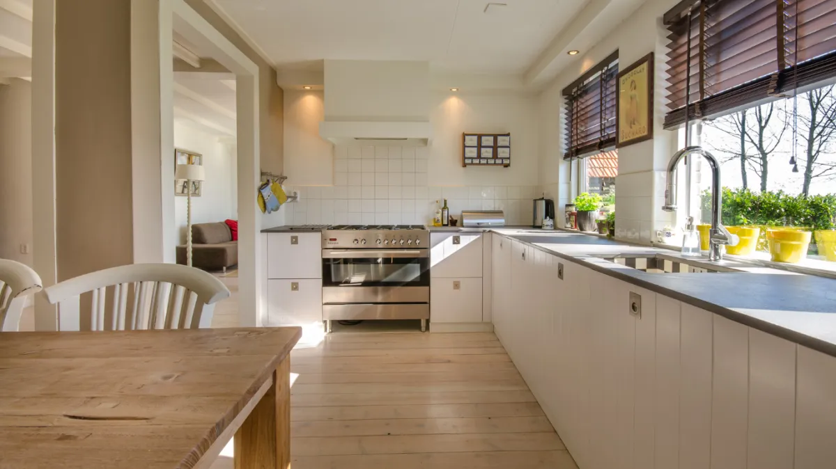 Bright and clean kitchen with large windows allowing natural light to shine through, showcasing the importance of spotless windows for enhancing home aesthetics and energy efficiency in Mildura.