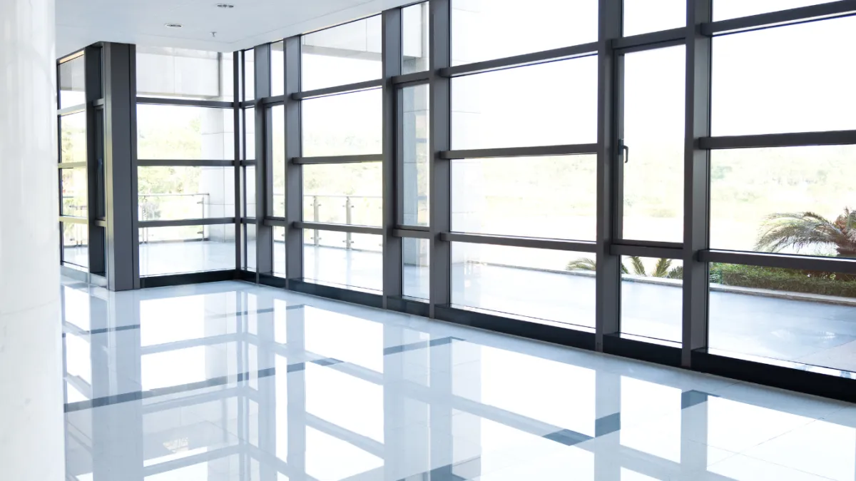 Bright, clean commercial windows in a modern building, showcasing the importance of professional window cleaning for enhancing natural light and maintaining a polished appearance.