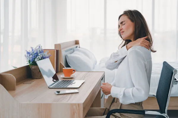 woman at her desk with neck pain