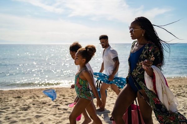 African American family walking on beach
