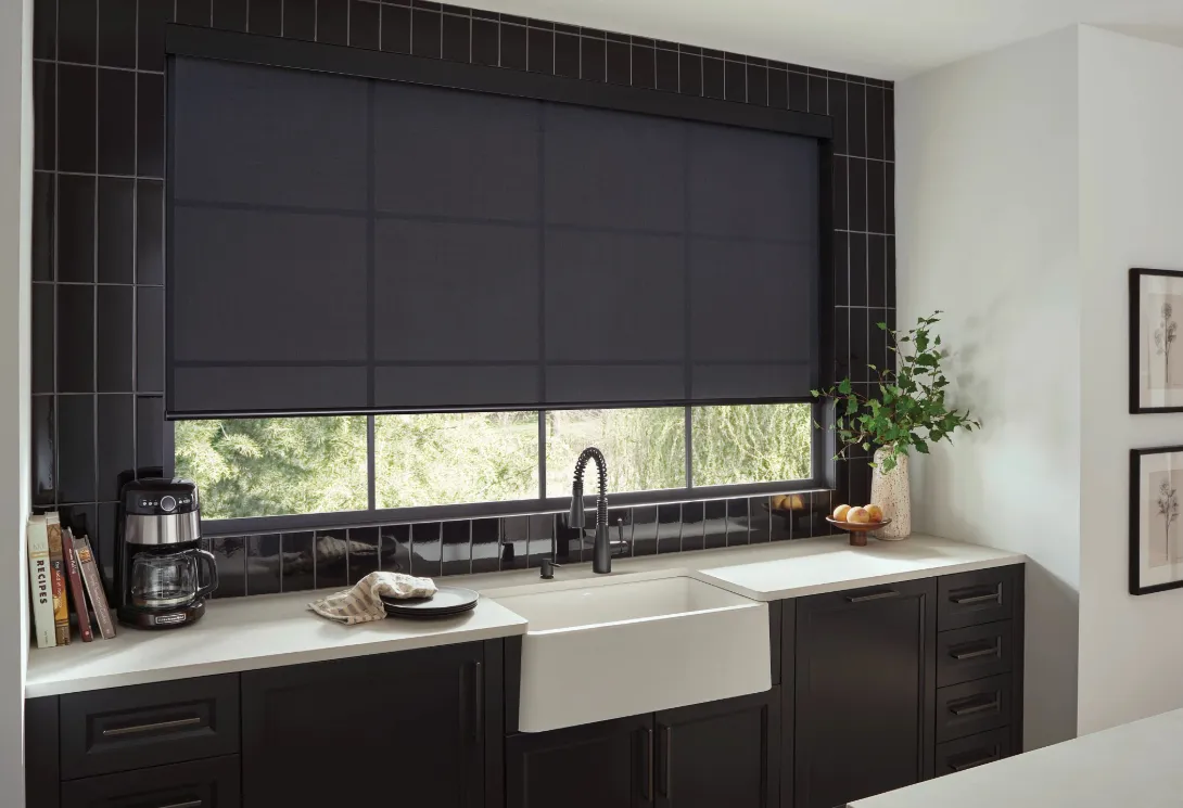 Automated roller shades in black above a kitchen sink, available at Fasada Windows and Doors Oakville.