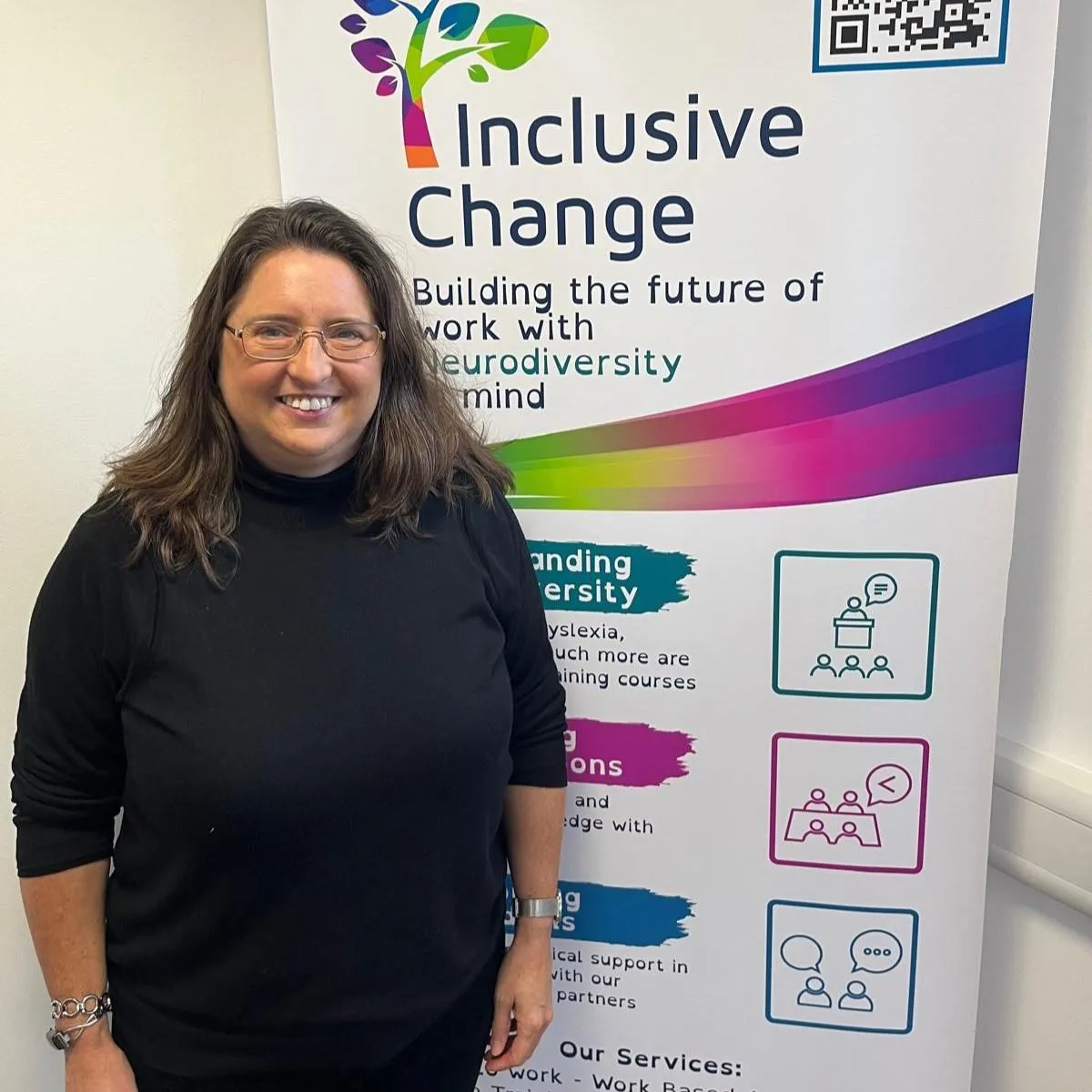 Image of Vicky Henderson smiling in front of the Inclusive Change banner.