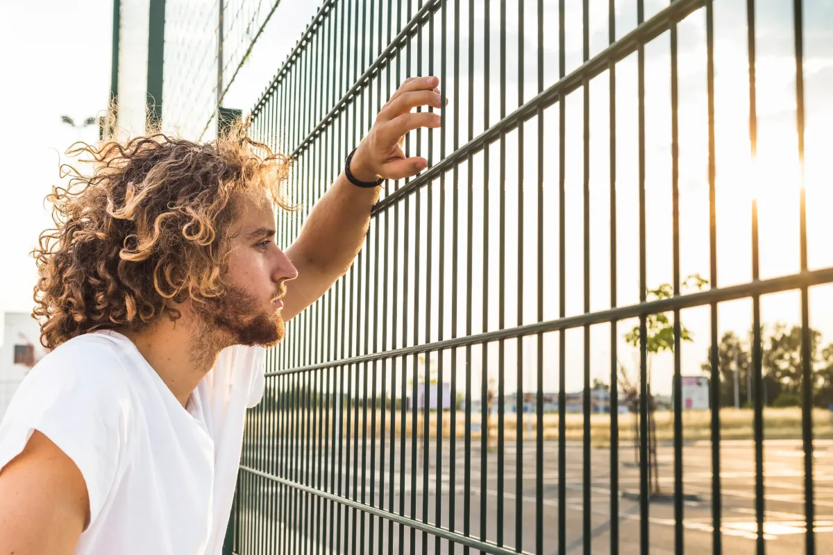 An Orange County Jail inmate looking through the fence