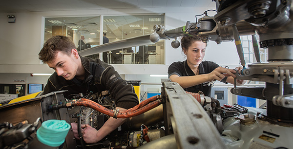 young people working on engine