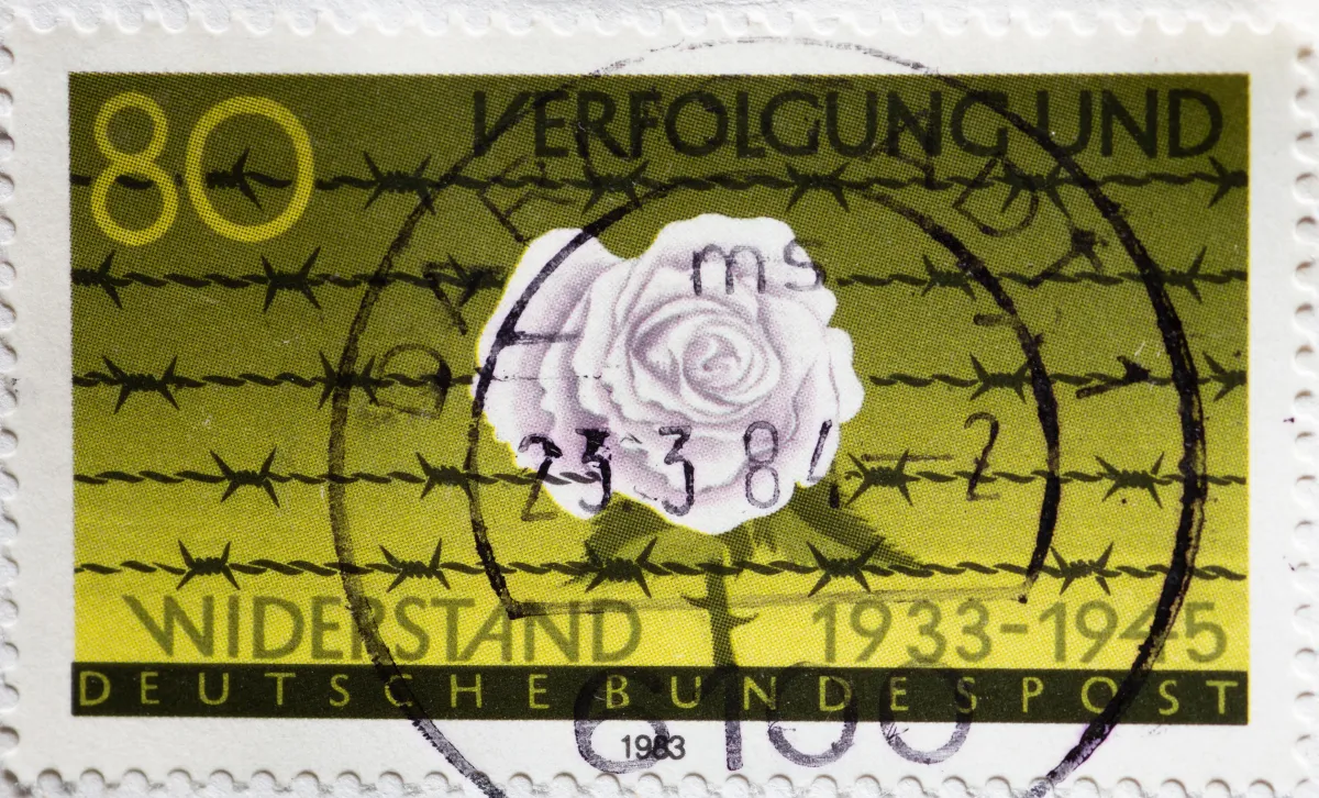 CIRCA 1983: white rose and barbed wire postage stamp from Germany